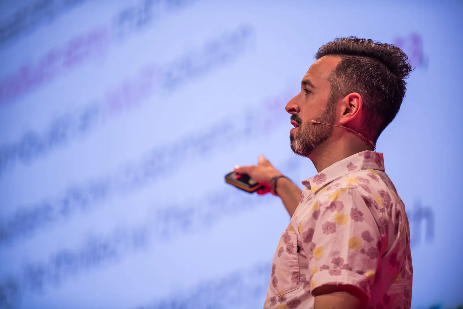 Rand Fishkin in a floral shirt speaking on stage at Turing Fest, clicker in hand
