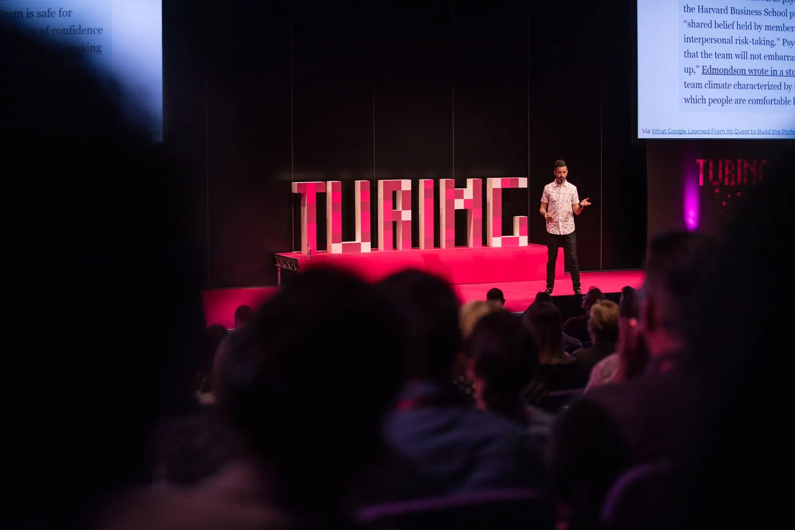 Rand Fishkin on the Turing Fest stage beside giant pink TURING letters, addressing the audience